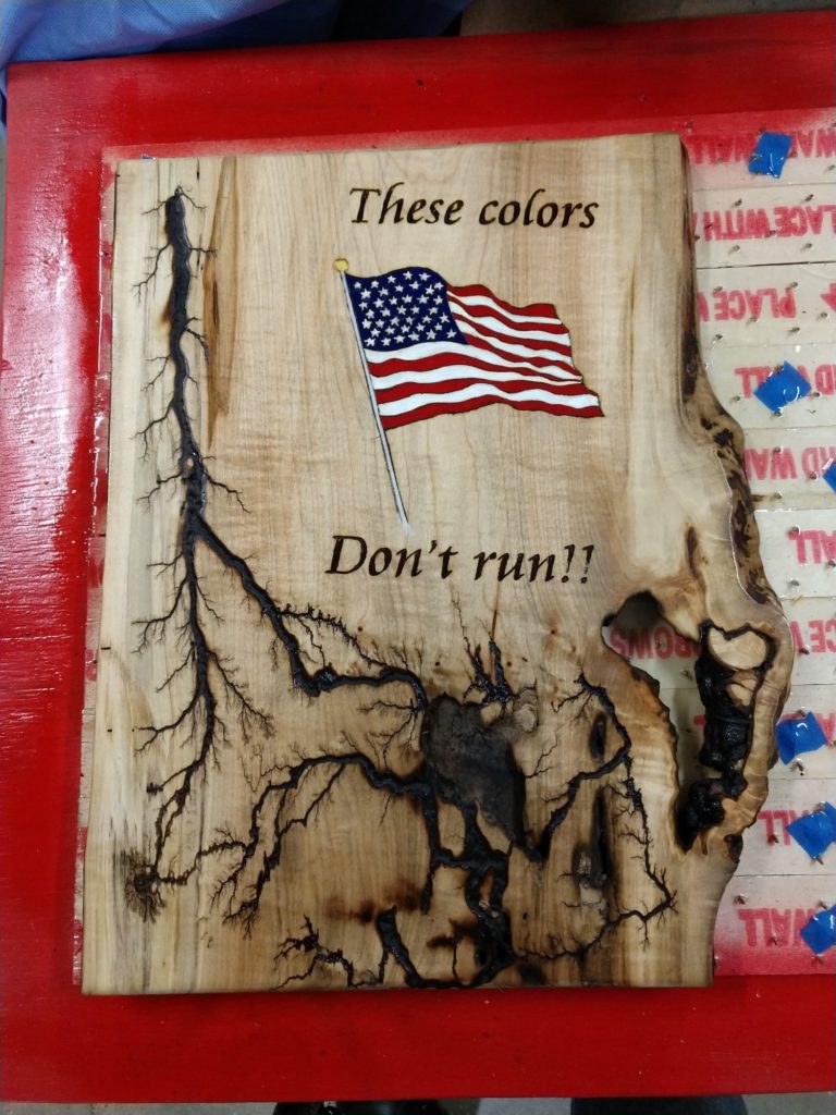 Board with "These colors Don't run!!" and colored flag